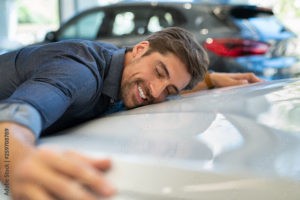 young man hugging new car stockpack adobe stock 300x200 - 5 Can't Miss Tips on Auto Insurance To Rack Up The Savings
